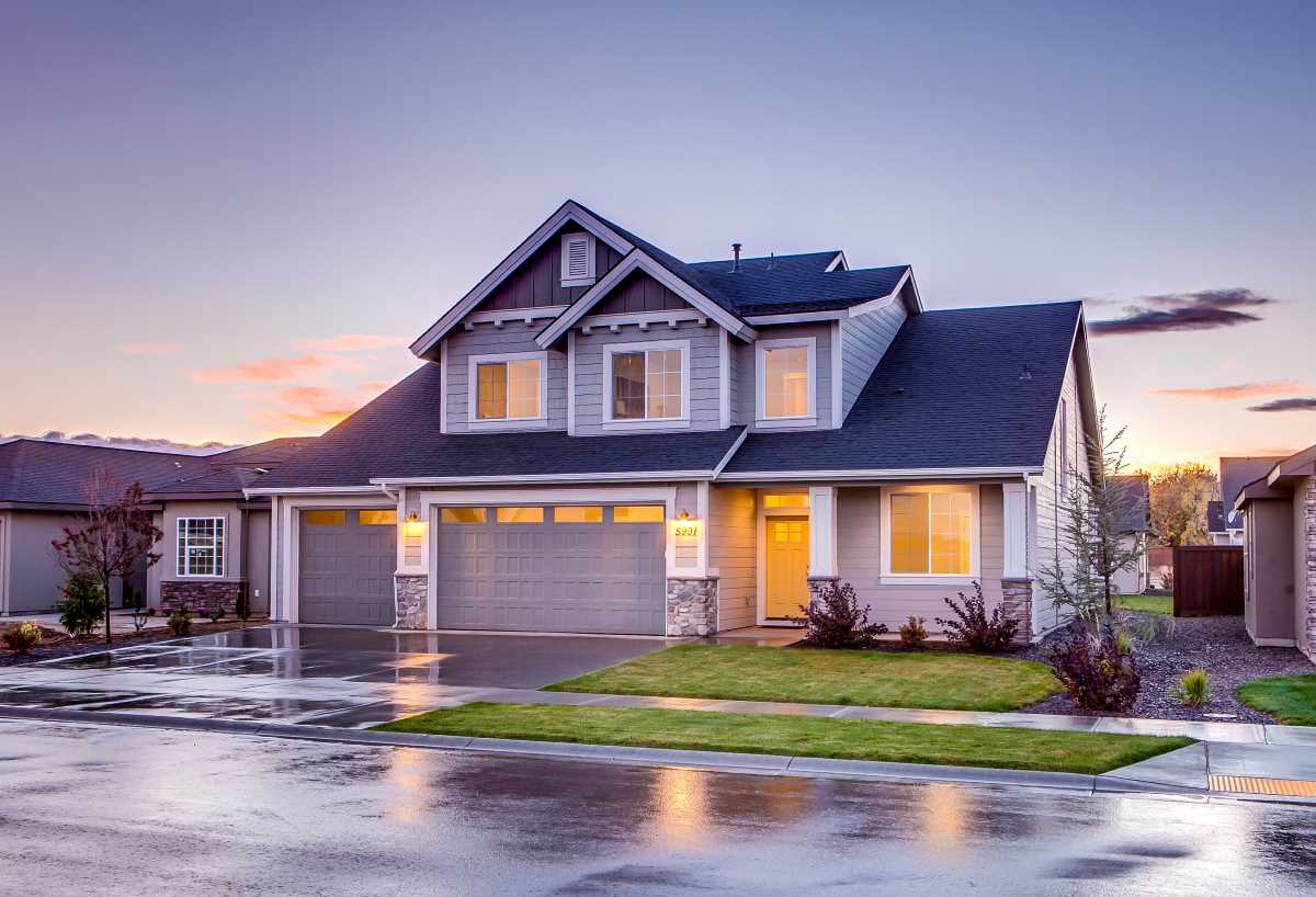 Beautiful home at dusk with warm interior lighting